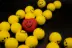 a red heart surrounded by yellow balls with smiley faces